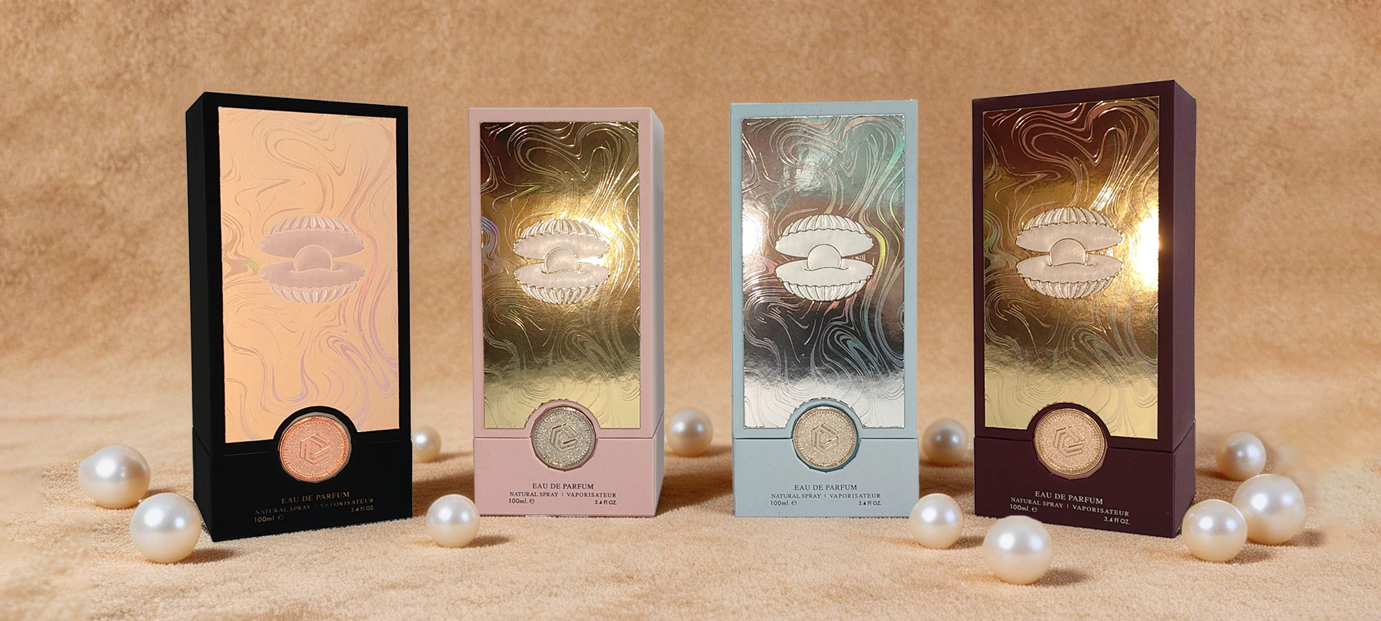Four slim perfume boxes with metallic shell motifs on a pearl-colored set